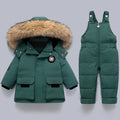 Green winter coat with fur hood and matching snowsuit on a light gray background