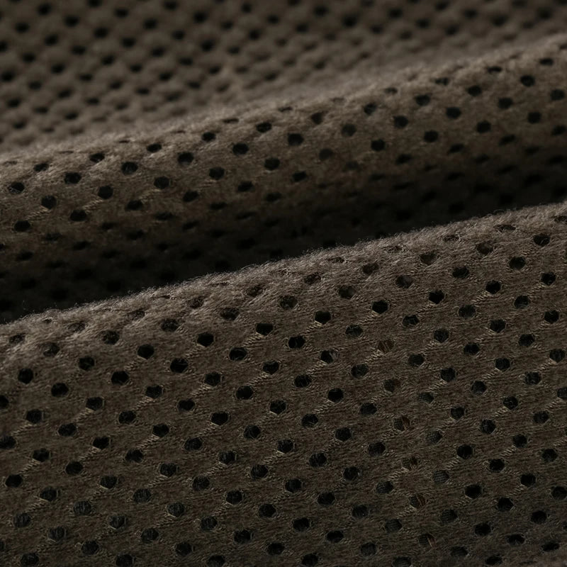 Close-up of brown perforated fabric texture