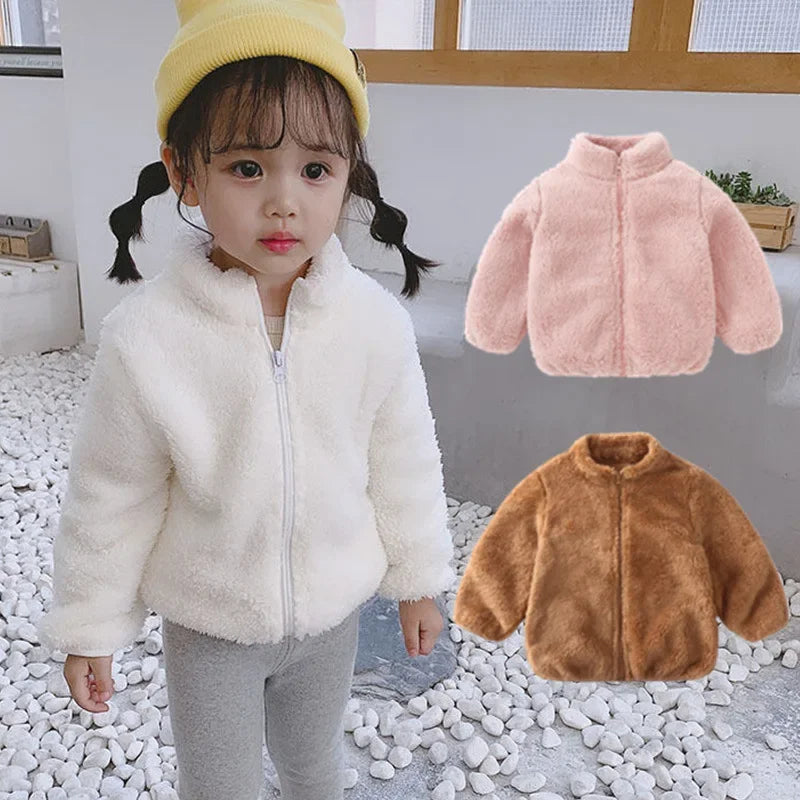 Child wearing a white fluffy jacket with inset images of pink and brown jackets.