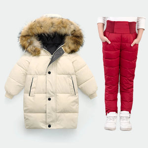 Beige puffer jacket with fur hood and red puffer pants on a white background
