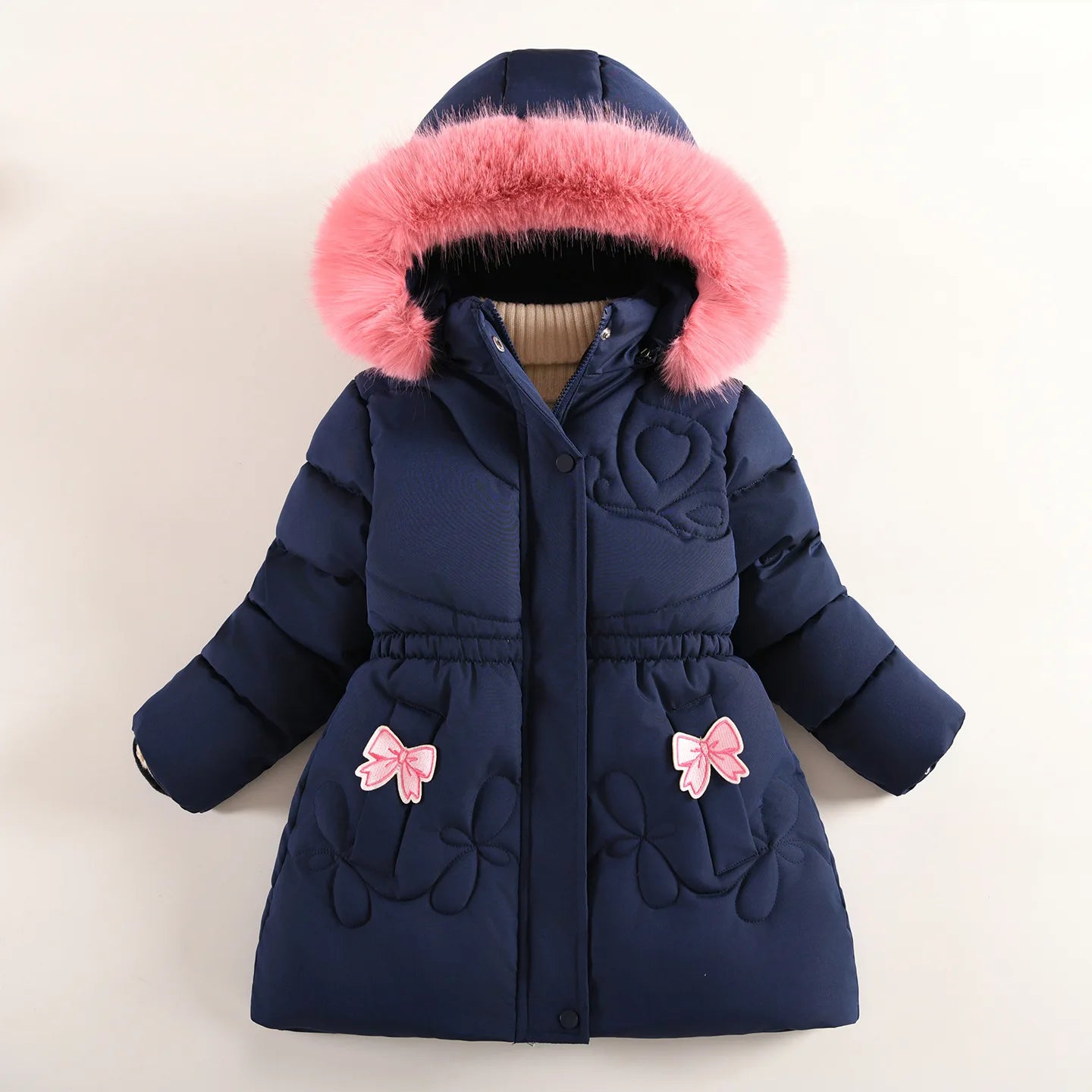 Navy blue children's coat with pink fur hood and bow details on a beige background