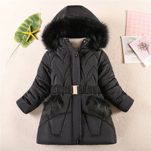 Black winter coat with fur hood and trim on a light background