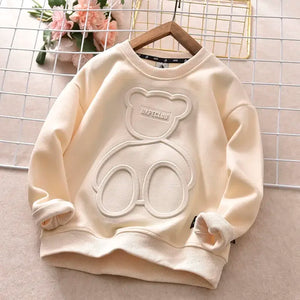 Beige sweatshirt with bear design on a hanger against a grid background