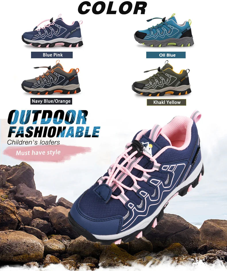 Children's outdoor fashion shoes in various colors with a prominent navy blue and pink shoe on rocks.