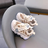 Pair of beige sneakers with LED lights on a gray chair