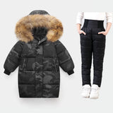 Camouflage puffer jacket with fur hood and black puffer pants on a white background