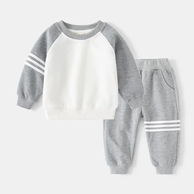 Children's gray and white sweatshirt and pants set on a light gray background