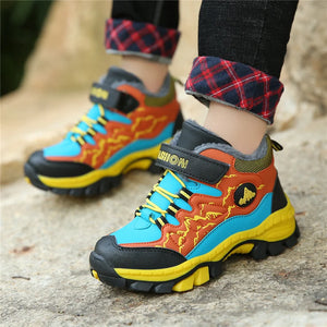 Colorful children's boots with visible brand logo on a textured surface