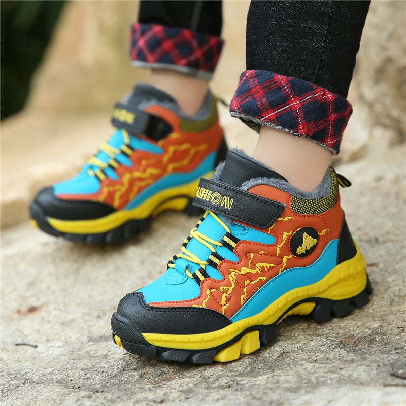 Colorful children's boots with visible brand logo on a textured surface