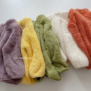 Row of colorful textured cloths on a white background