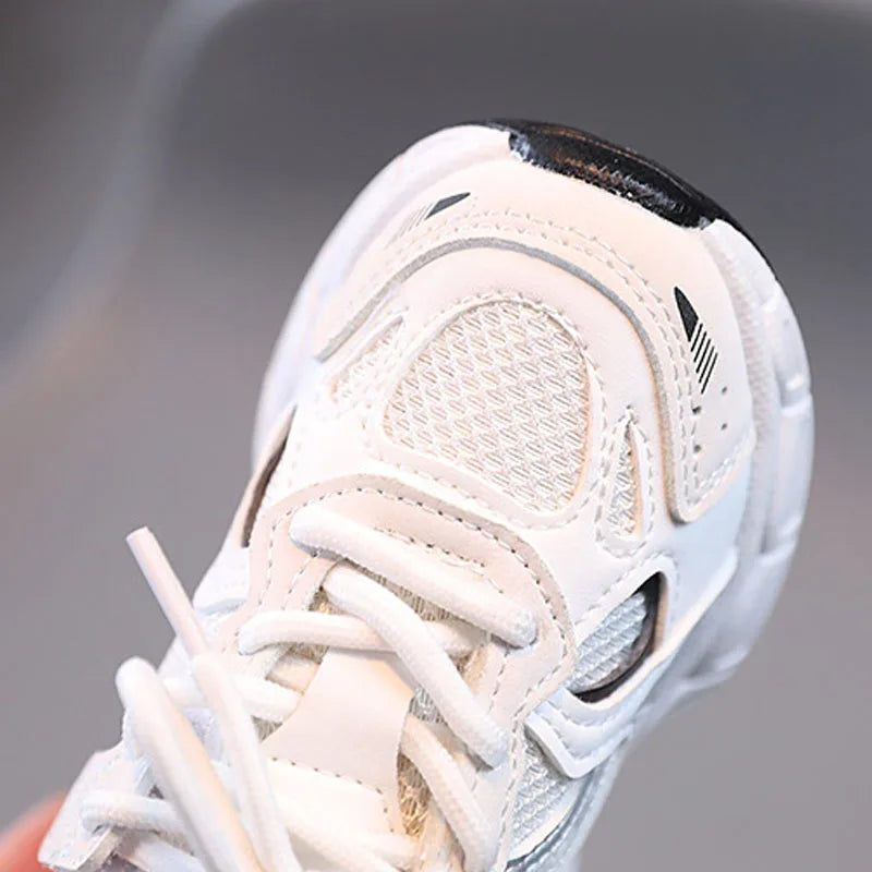 White sneaker with black accents on a gray background