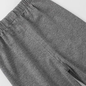 Close-up of gray sweatpants on a light gray background