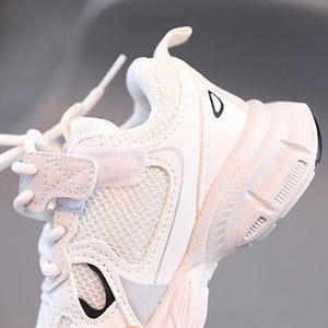 Close-up of a white sneaker with black accents on a blurred background