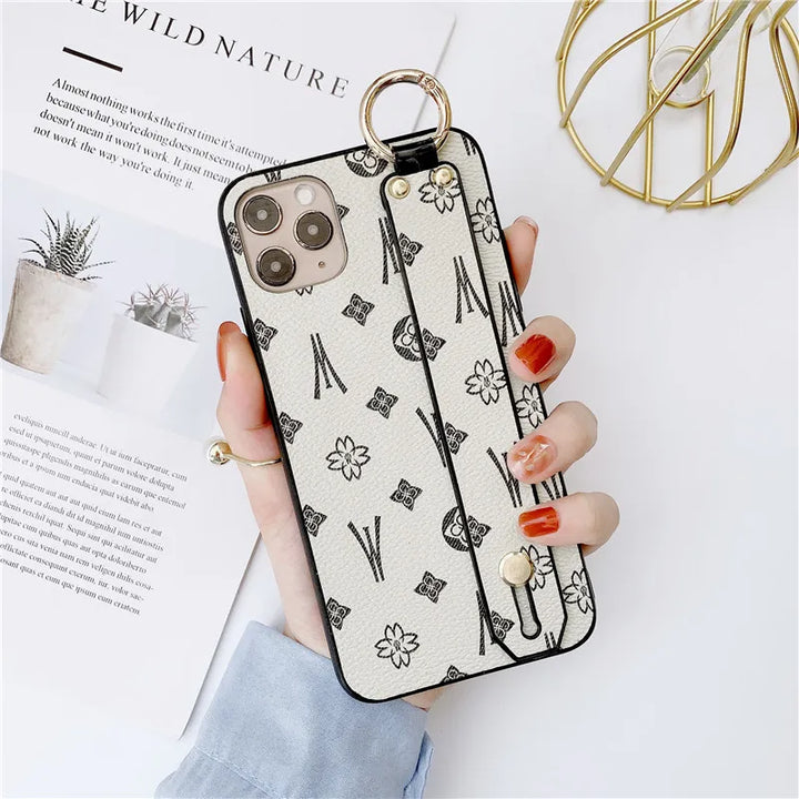 Luxury leather wristband phone case for iPhone, featuring jeweled and fabric designs, durable and stylish.