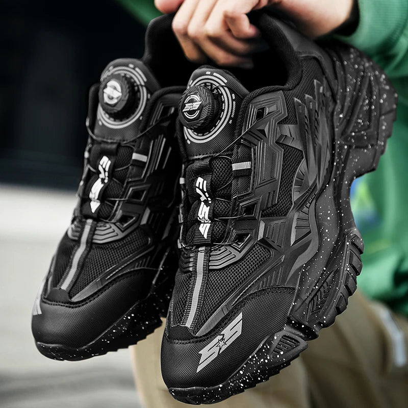 Black hiking boots with brand logo held by a person