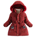 Red winter coat with fur-lined hood on a gray background