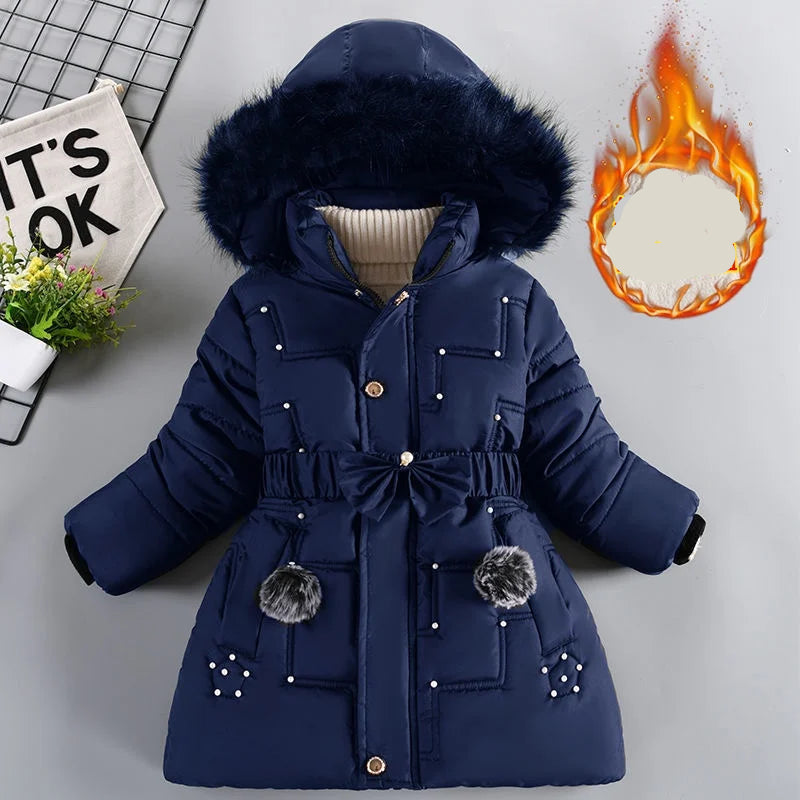 Blue children's winter coat with fur hood on a light gray background