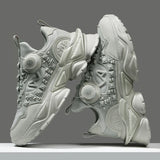 Pair of futuristic gray sneakers on a gray background
