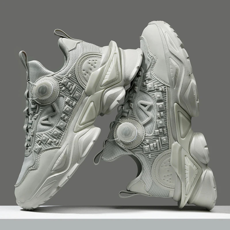 Pair of futuristic gray sneakers on a gray background