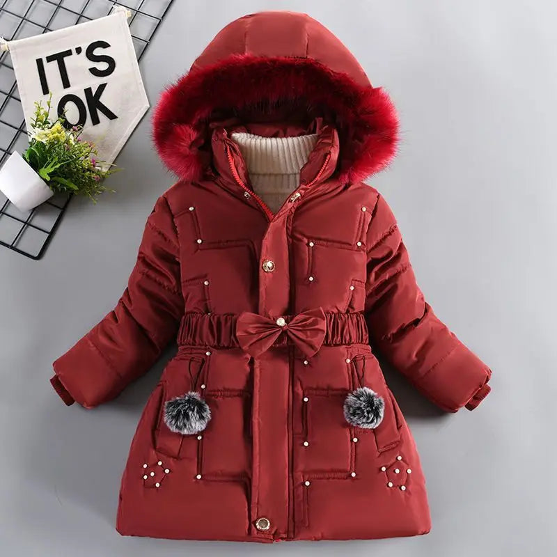 Red winter coat with fur-lined hood on a gray background