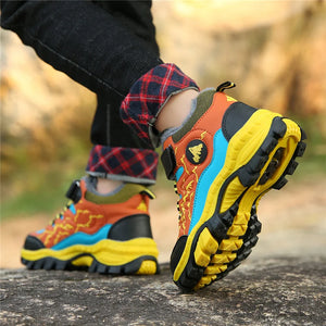 Colorful hiking boots with a textured sole on a natural background