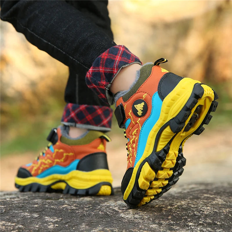 Colorful hiking boots with a textured sole on a natural background
