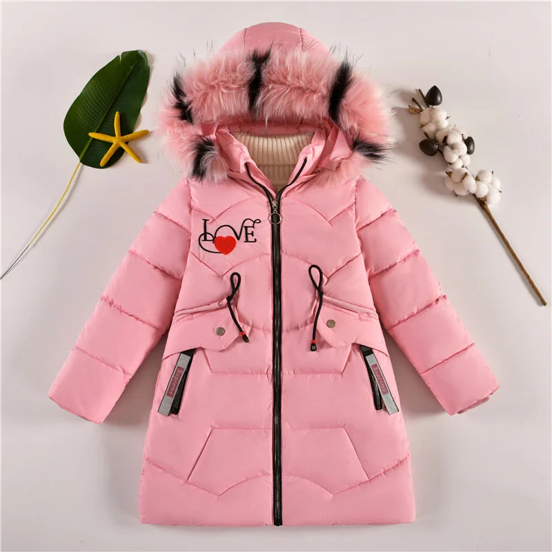 Pink children's coat with fur hood on a light gray background
