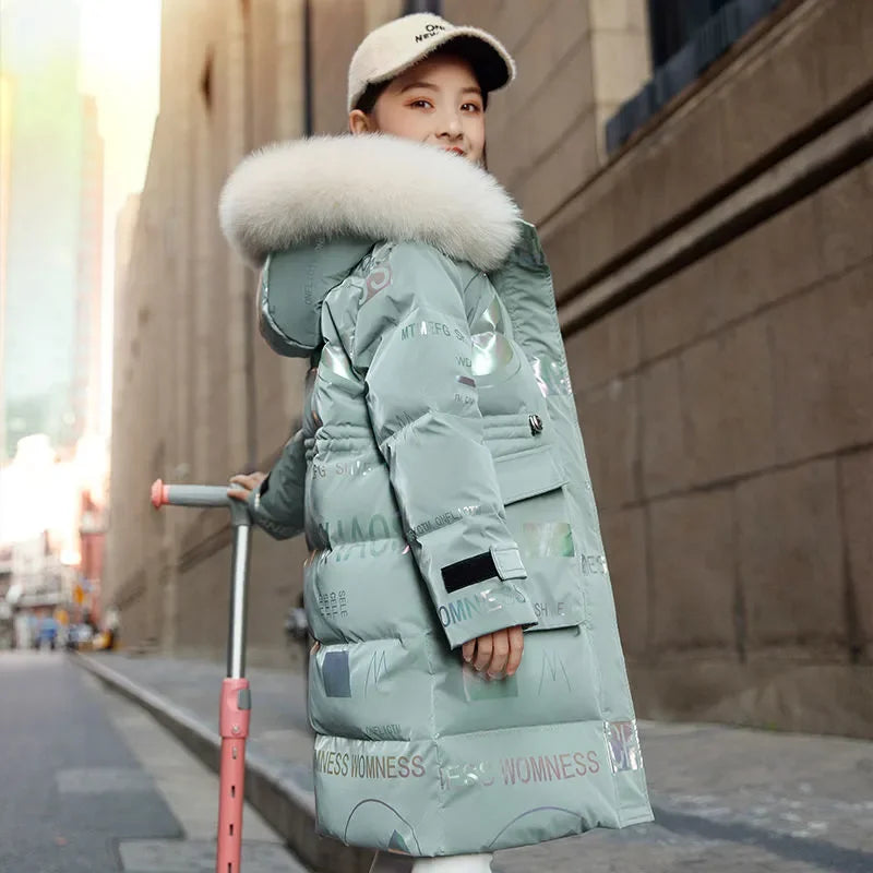 Person wearing a long light blue puffer coat with a fur-lined hood on a city street.