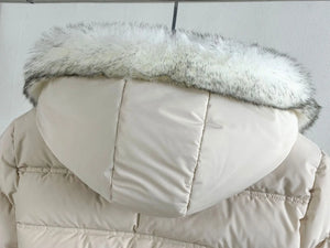 Beige puffer jacket with a fur-lined hood on a light gray background