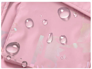 Pink fabric with water droplets, likely demonstrating water resistance.