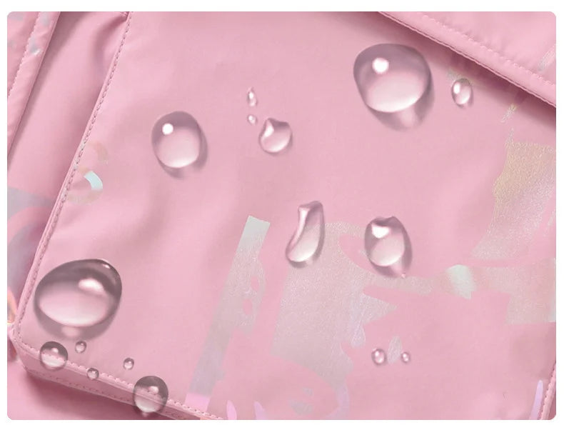 Pink fabric with water droplets, likely demonstrating water resistance.