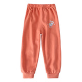 Coral sweatpants with a small logo on a white background