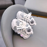 White sneakers with text labels on a gray chair