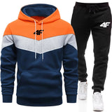 Color-blocked hoodie and black jogger pants with a brand logo on a white background