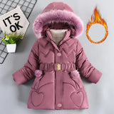 Pink children's winter coat with fur hood on a gray background