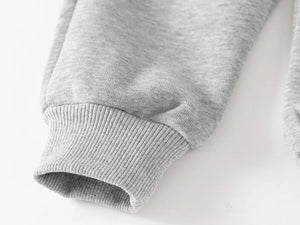 Close-up of a gray sweater sleeve on a white background