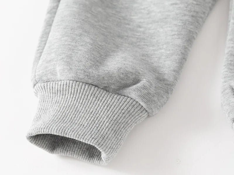 Close-up of a gray sweater sleeve on a white background