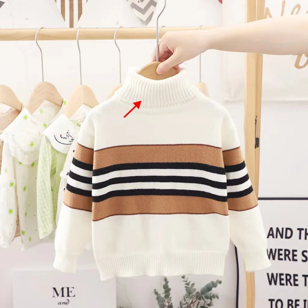 Children's striped sweater on a hanger with a blurred background