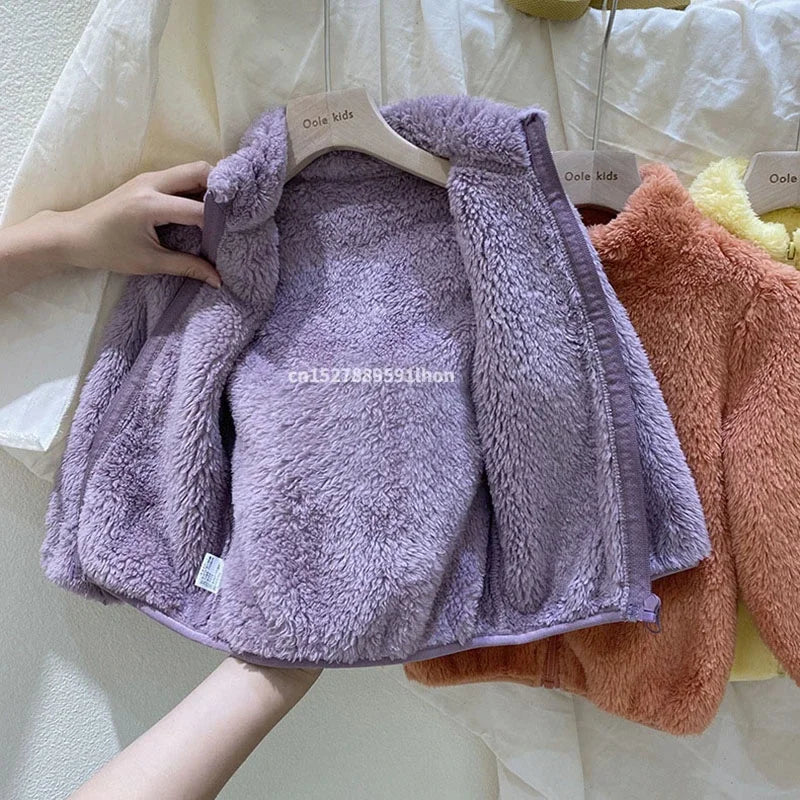 Purple children's coat on a hanger with a blurred background