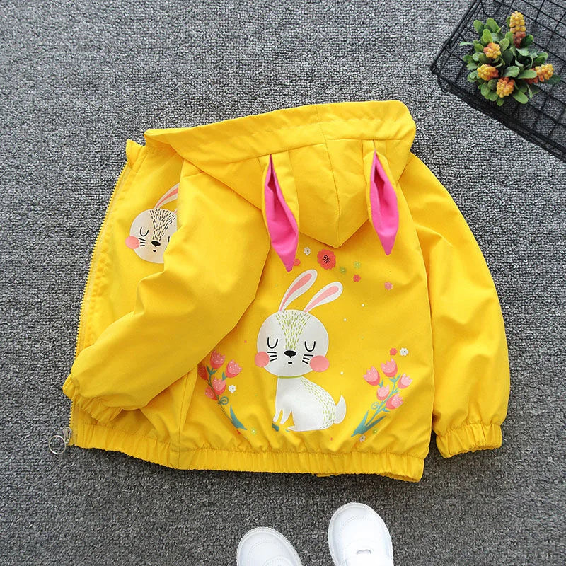 Yellow children's jacket with bunny design on a gray surface