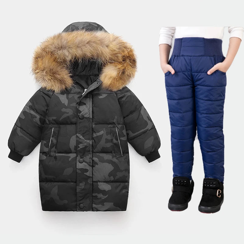 Black camouflage puffer coat with fur hood and blue puffer pants on a white background