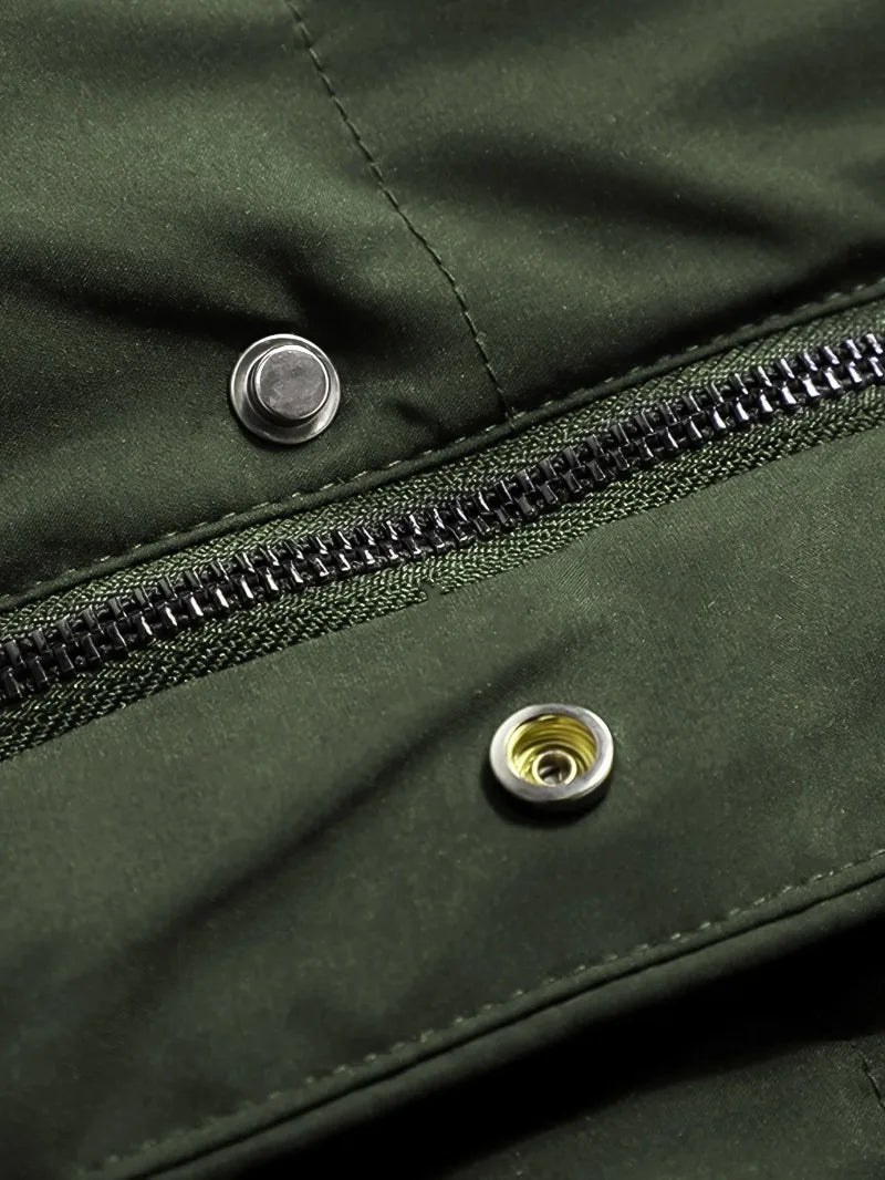 Close-up of a green jacket with a zipper and buttons.