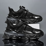 Stack of black and gray sneakers on a reflective surface with a gray background