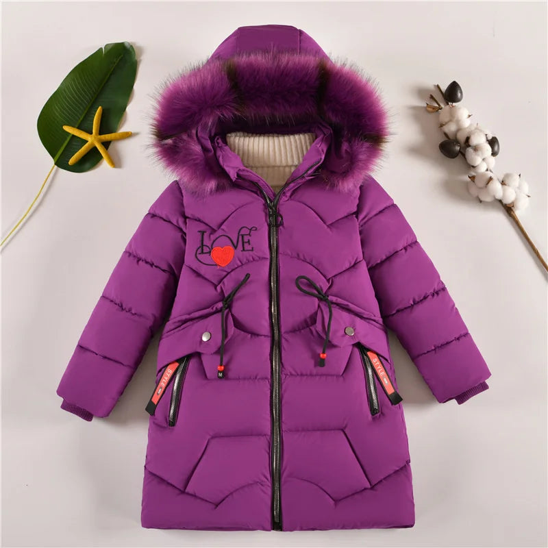 Purple children's coat with fur-lined hood on a light gray background