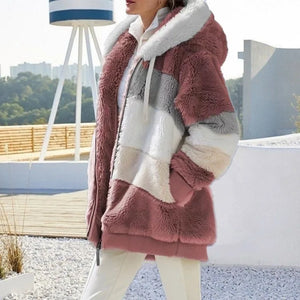 Person wearing a colorful fur coat with a blurred outdoor background