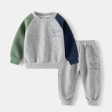 Children's sweatshirt and pants set with dinosaur design on a white background