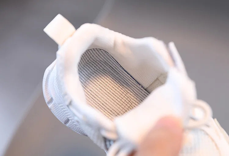 Close-up of a white sneaker with a textured sole