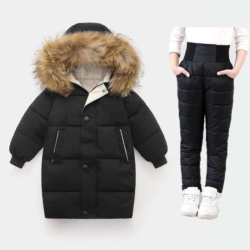 Black puffer jacket with fur hood and black puffer pants on a white background