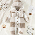 Plaid baby onesie with hood on a soft white background