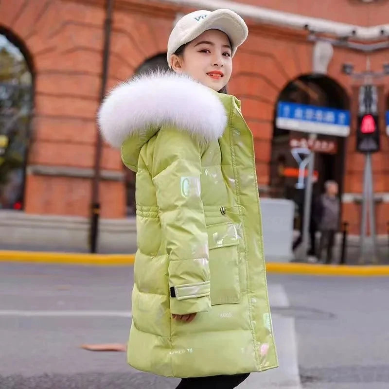 Person wearing a light green puffer jacket with a large fur hood in an urban setting.